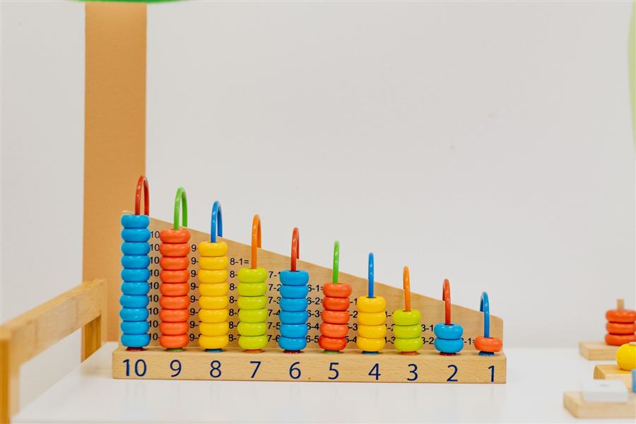 Close-up of a colorful wooden counting toy with numbers and shapes, perfect for preschool